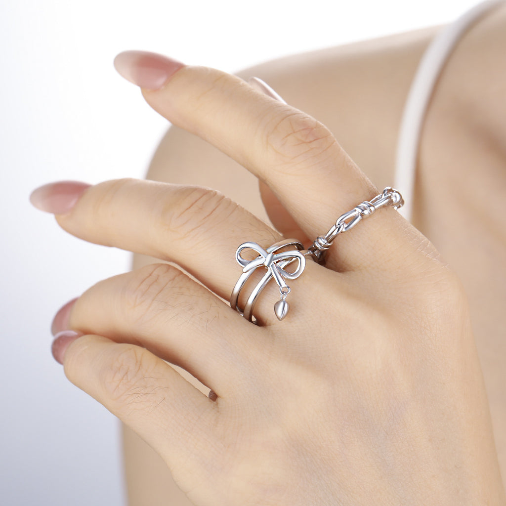 Adjustable double band ring with knot and heart charms in 925 sterling silver 